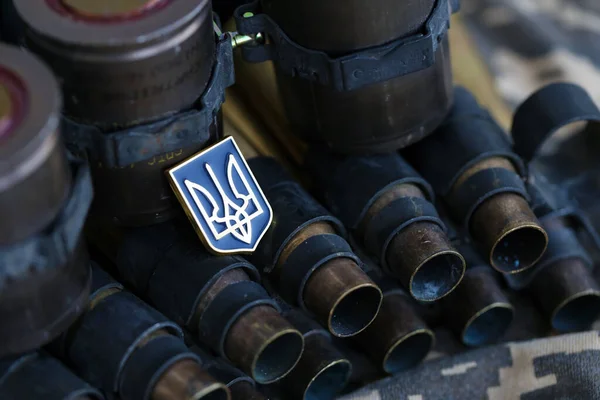 Ukrainian symbol on machine gun belt lies on ukrainian pixeled military camouflage close up