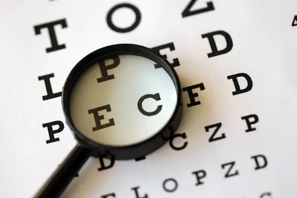 Magnifier Glass Focuses Eye Chart Letters Clearly Lies Eye Test — Stock Photo, Image