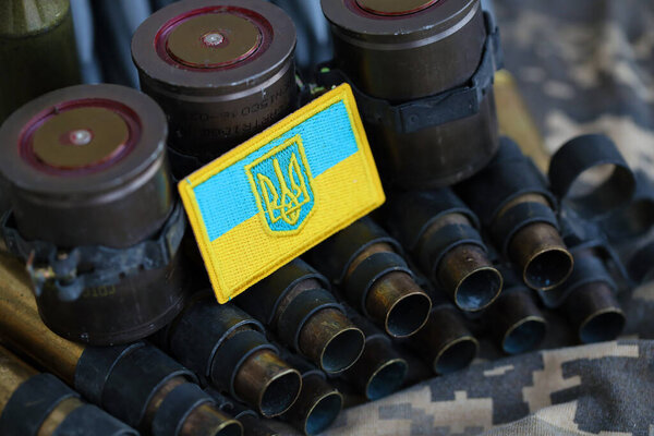 Украинский символ на пулемётном поясе лежит на украинском пиксельном военном камуфляже вблизи