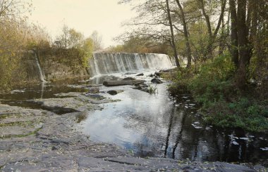 An abandoned dam, an artificial waterfall, the dam of the Butka HPP, is located up the river behind the bridge over the Hirsky Tikich river