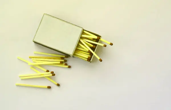 Open cardboard matchbox filled with matches on a white background. Flat lay minimal. Top view with text space