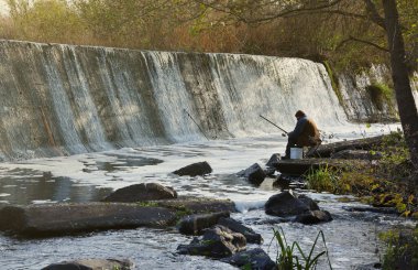 An abandoned dam, an artificial waterfall, the dam of the Butka HPP, is located up the river behind the bridge over the Hirsky Tikich river