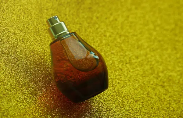 Women fragrance perfume bottle on yellow background close up. Unnamed blank sprayer bottle of perfume for women