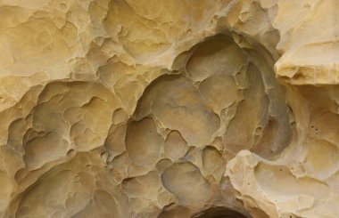 Combination of stone relief like a orange planet surface. Brown stone with abnormal relief shape with specific light