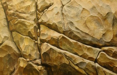 Light coarse natural rock stone background. Mining cliff rough front surface. Big limestone stack backdrop. Heavy grunge damaged granite block texture. Crack antique medieval stony facade for design