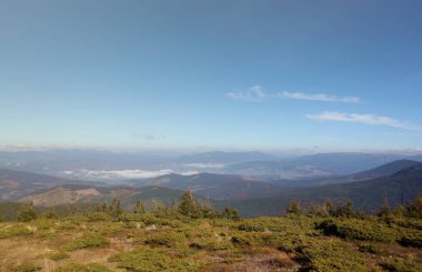 Ukrayna Karpatlarının gökyüzü ve bulutların arka planında asılı duran Hoverla Dağı manzarası