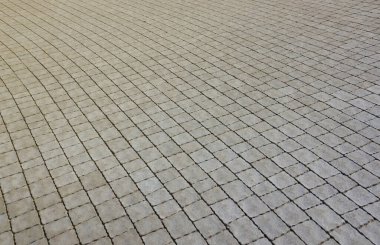 Yaya kaldırımındaki gri asfalt levhalar. Sert kaldırım taşı desenli, kare şeklinde birçok taş var.