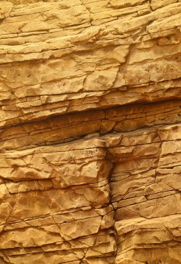 Light coarse natural rock stone background. Mining cliff rough front surface. Big limestone stack backdrop. Heavy grunge damaged granite block texture. Crack antique medieval stony facade for design