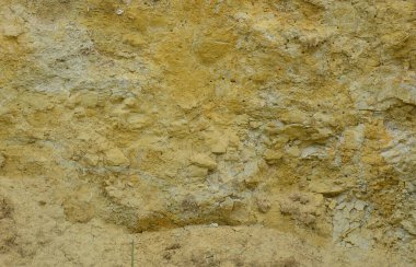 Bir duvar sağlam sarı ve kahverengi doku kum kumlu ocağında