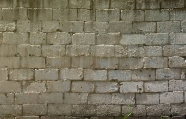 Parlak güneş ışığı altında kabartma taş tuğla duvar dokusu