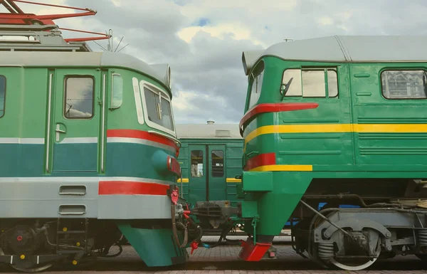Cabs of modern Russian electric trains. Side view of the heads of railway trains with a lot of wheels and windows in the form of portholes