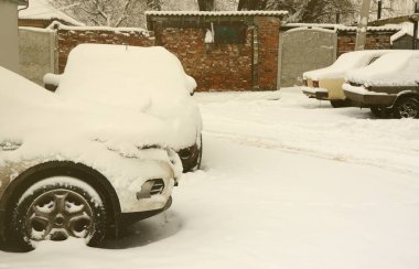 Şiddetli bir kar yağışı sonrası arabanın parçası bir kar tabakasının altında. Arabanın vücudu beyaz karla kaplı.