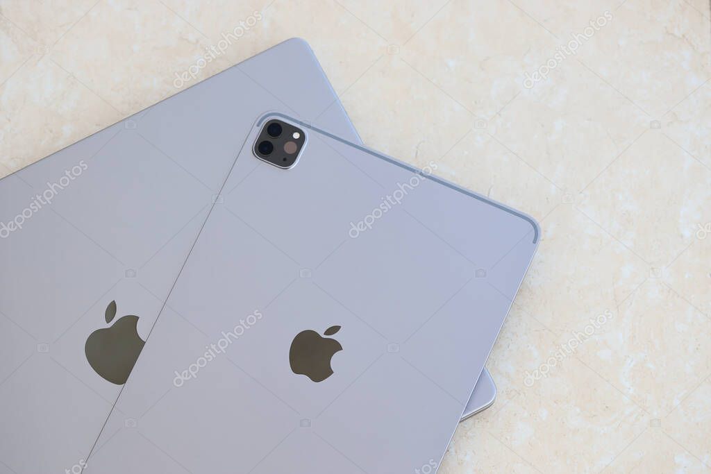 KYIV, UKRAINE - 4 MAY, 2023: Apple brand device ipad lies on macbook body close up