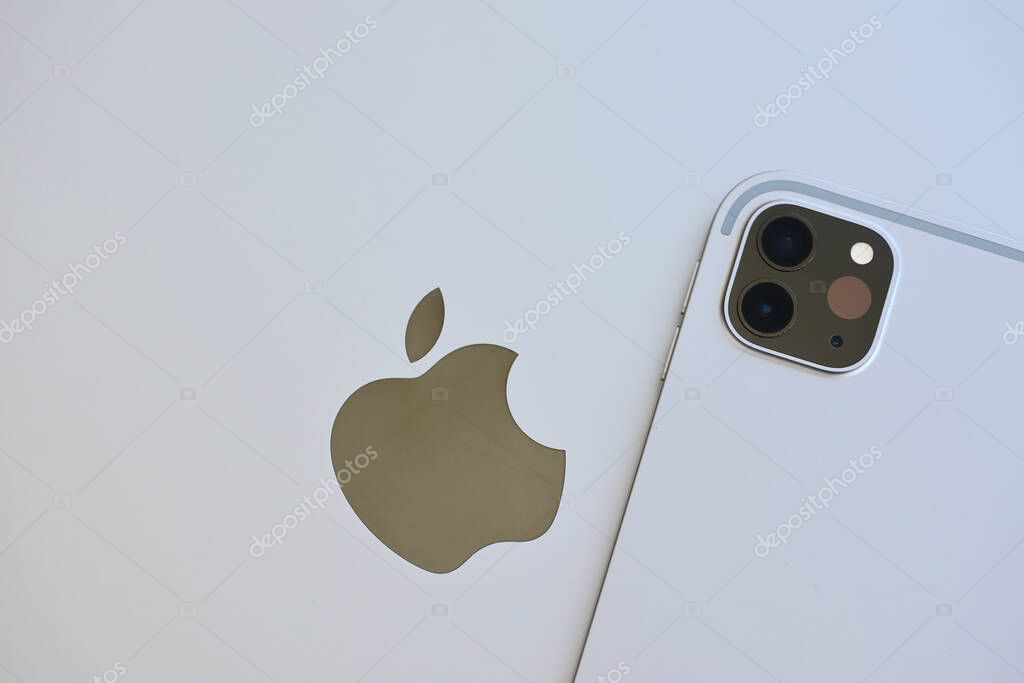 KYIV, UKRAINE - 4 MAY, 2023: Apple brand device ipad lies on macbook body close up