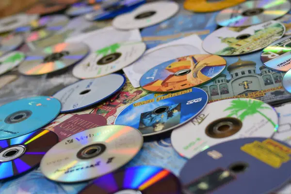 stock image KYIV, UKRAINE - 4 MAY, 2023: Many old CDs represent technology from the 90s. Stacks of CDs, old songs and old movies. which had been used before