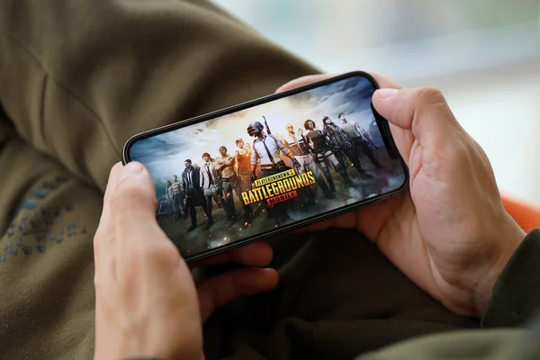 stock image PUBG PlayerUnknowns Battlegrounds mobile iOS game on iPhone 15 smartphone screen in male hands during mobile gameplay. Mobile gaming and entertainment on portable device