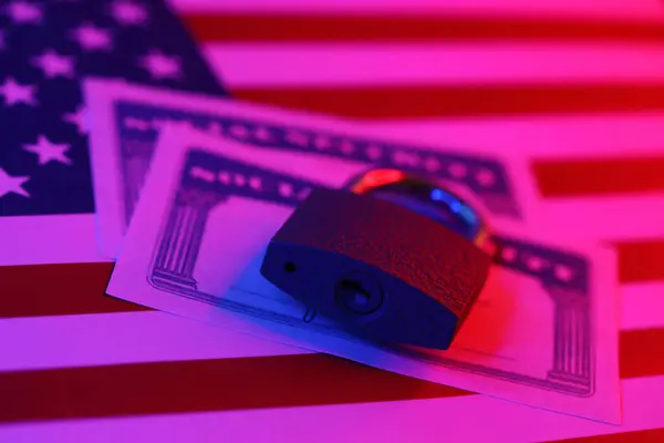 Padlock and social security card on United States flag close up. Identity theft and identity protection concept