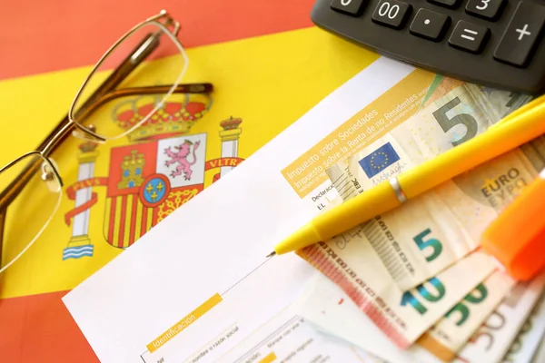 Modelo 200 spanish tax form for corporate income tax for non resident taxpayer lies on flag of Spain close up on accountant table