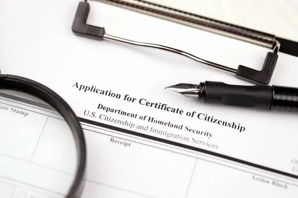 stock image N-600 Application for Certificate of Citizenship blank form on A4 tablet lies on office table with pen and magnifying glass close up