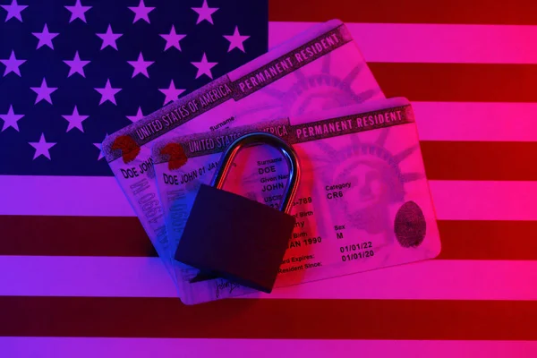 Permanent resident green card for US DV-lottery with small padlock on US flag close up
