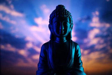 Buddha Purnima ve Vesak Günü konsepti, güzel ve renkli arka plana karşı yumuşak ışık saçan Buda heykeli. Meditasyon