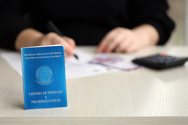 stock image Brazilian work card and social security blue book lies on accountant or boss table close up