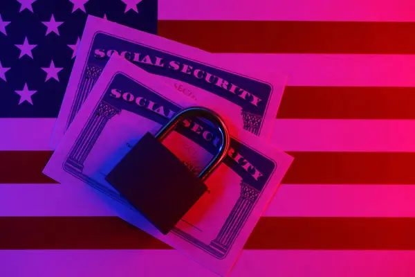 Padlock and social security card on United States flag close up. Identity theft and identity protection concept
