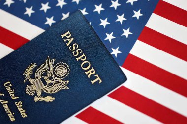 Amerika Birleşik Devletleri 'nin yeni mavi pasaportu Amerikan Bayrağı arka planında. ABD vatandaşlığı alma kavramı