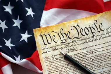 Preamble to the Constitution of the United States and American Flag. Old yellow paper with We The People text clipart