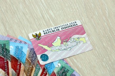Indonesia child identity card Kartu Identitas Anak or KIA card. ID document for indonesian children close up clipart