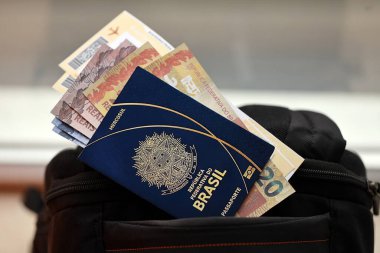 Paralı mavi Brezilya pasaportu ve turistik sırt çantasında uçak biletleri. Turizm ve seyahat kavramı