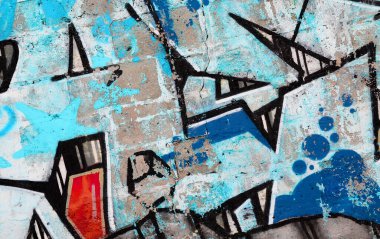 Duvarında parlak aerosol çizgileri olan grafiti resimlerinin renkli arka planı. Eski moda sokak sanatı sprey boya kutularından yapılmış. Çağdaş gençlik kültürü arka planı