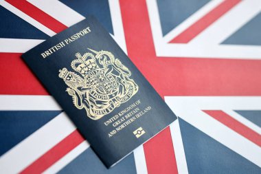 Ulusal arkaplanda mavi İngiliz pasaportu var. Yakın plan. Turizm ve vatandaşlık kavramı