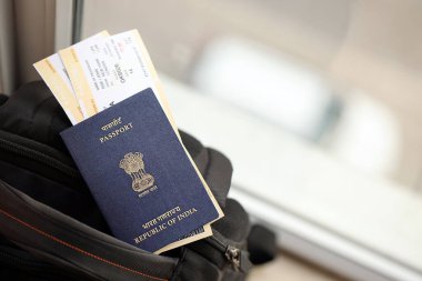 Turistik sırt çantasında uçak biletleri olan mavi Hindistan pasaportu. Turizm ve seyahat kavramı