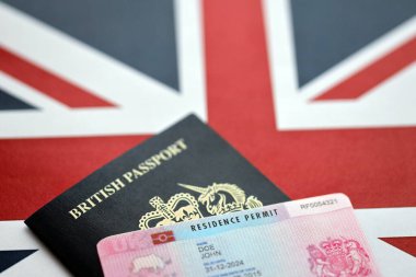 Oturma izni belgesi BRP kartı ve Birleşik Krallık 'ın İngiliz pasaportu İngiliz bayrağı kapanıyor.