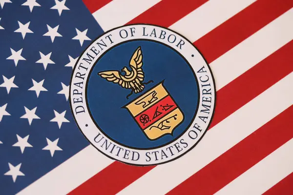 stock image KYIV, UKRAINE - MARCH 9, 2024 US Department of Labor seal on United States of America flag close up