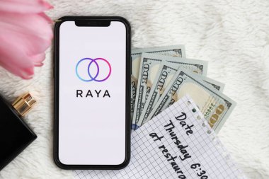 KYIV, UKRAINE - FEBRUARY 23, 2024 Raya logo of famous dating website or app on iPhone display screen close up clipart