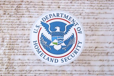 KYIV, UKRAINE - MARCH 9, 2024 US Department of Homeland Security seal on United States Constitution close up clipart