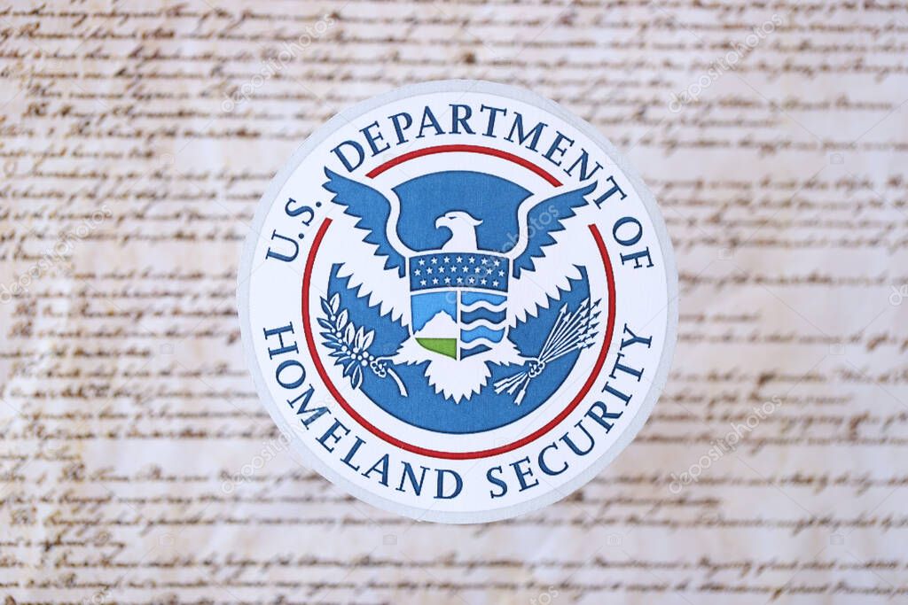 KYIV, UKRAINE - MARCH 9, 2024 US Department of Homeland Security seal on United States Constitution close up