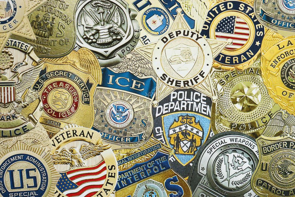 KYIV, UKRAINE - MARCH 9, 2024 Badges of different United States police departments printed on paper close up