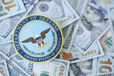 KYIV, UKRAINE - MARCH 9, 2024 US Department of Defense seal on many US hundred dollar bills close up clipart