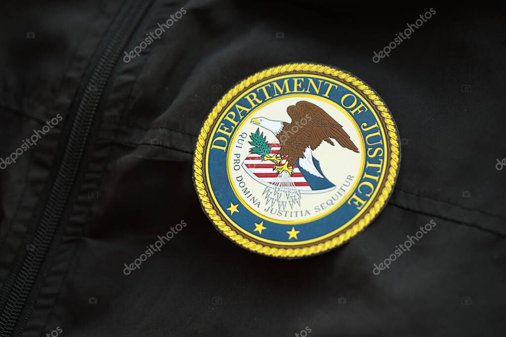 KYIV, UKRAINE - MARCH 9, 2024 US Department of Justice seal on black jacket uniform close up