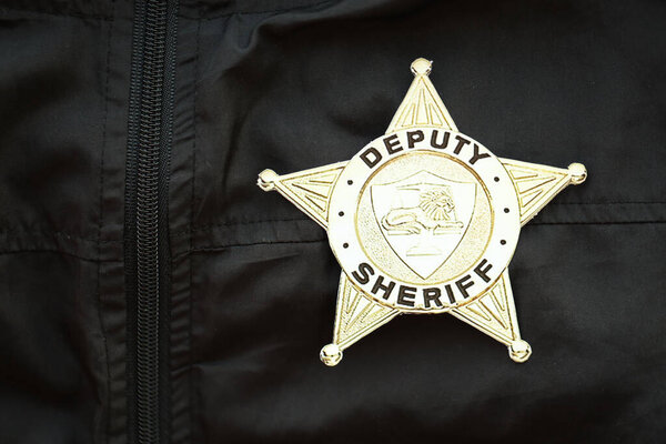 KYIV, UKRAINE - MARCH 9, 2024 US Deputy Sheriff badge on black jacket uniform close up