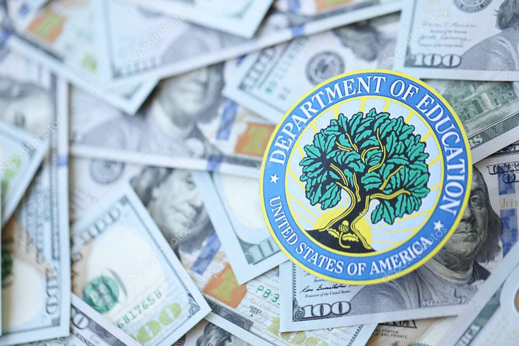 KYIV, UKRAINE - MARCH 9, 2024 US Department of Education seal on many US hundred dollar bills close up