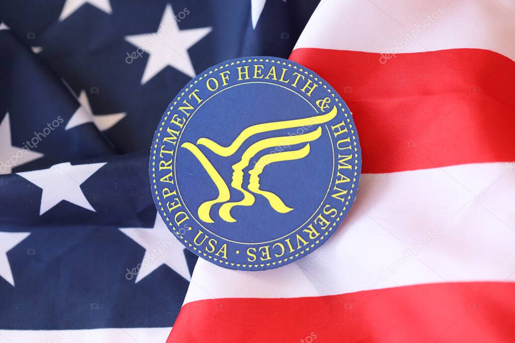 KYIV, UKRAINE - MARCH 9, 2024 US Department of Health and human Services seal on United States of America flag close up