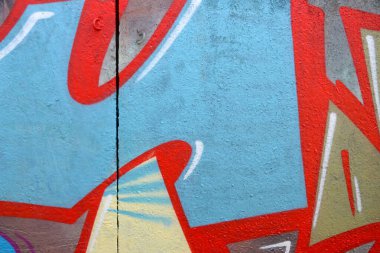 Duvarında parlak aerosol çizgileri olan grafiti resimlerinin renkli arka planı. Eski moda sokak sanatı sprey boya kutularından yapılmış. Çağdaş gençlik kültürü arka planı