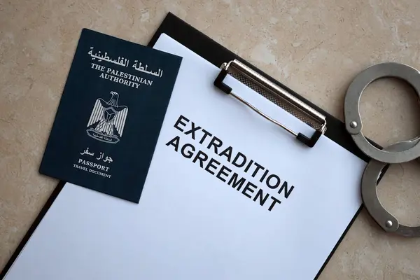 stock image Passport of Palestinian Authority and Extradition Agreement with handcuffs on table close up