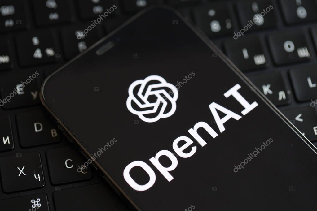 KYIV, UKRAINE - MARCH 17, 2024 OpenAI logo on iPhone display screen and MacBook keyboard. Artificial Intelligence engine