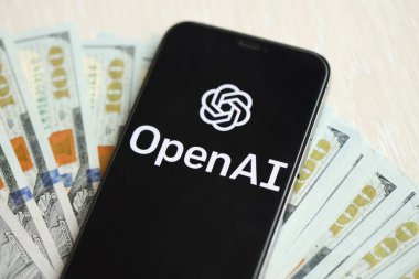 KYIV, UKRAINE - 17 Mart 2024 OpenAI logosu iPhone ekranında yüzlerce dolarlık banknotlarla. Yapay Zeka Motoru