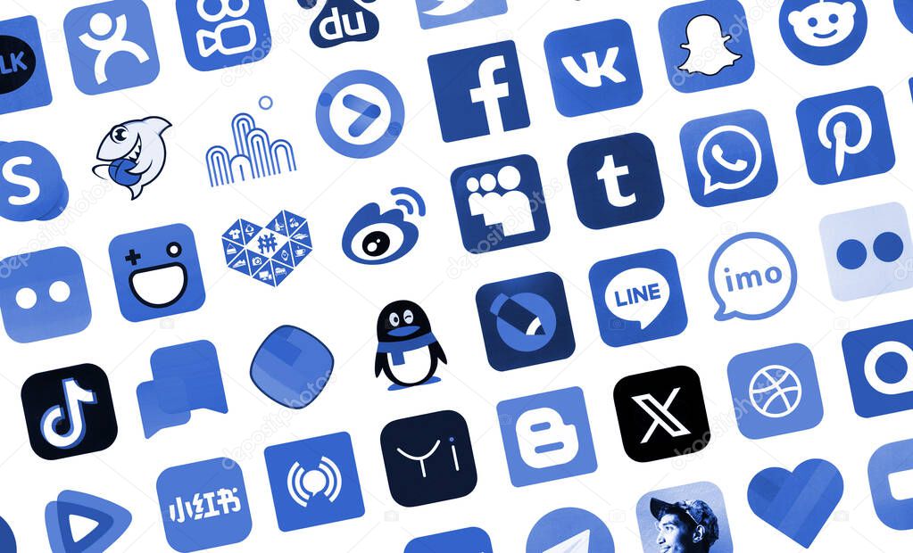 KYIV, UKRAINE - APRIL 1, 2024 Many icons of social media, messengers, video sharing platforms and other popular services and websites printed on white paper in blue color